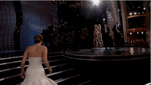 Jennifer Lawren cầm rượu, trèo qua ghế để đến chỗ ngồi tại Oscar 2018
